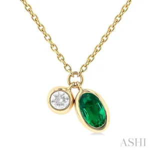 1/50 ctw Oval Cut 6X4MM Emerald and Bezel Set Round Cut Diamond Precious Necklace in 10K Yellow Gold